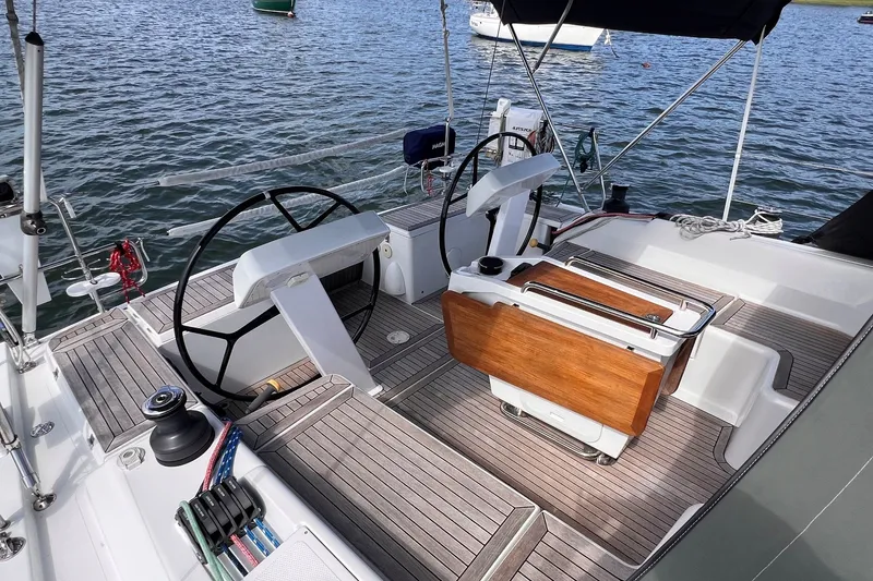 Slide: The Image of Cockpit of 2020 Hanse 458 yacht with dual steering wheels and teak flooring. - 18