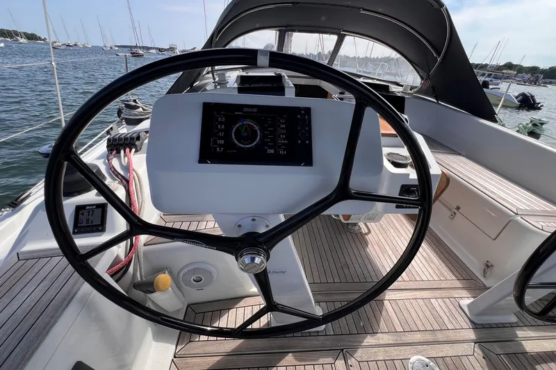 Slide: The Image of Cockpit of 2020 Hanse 458 yacht with steering wheel and navigation display. - 25