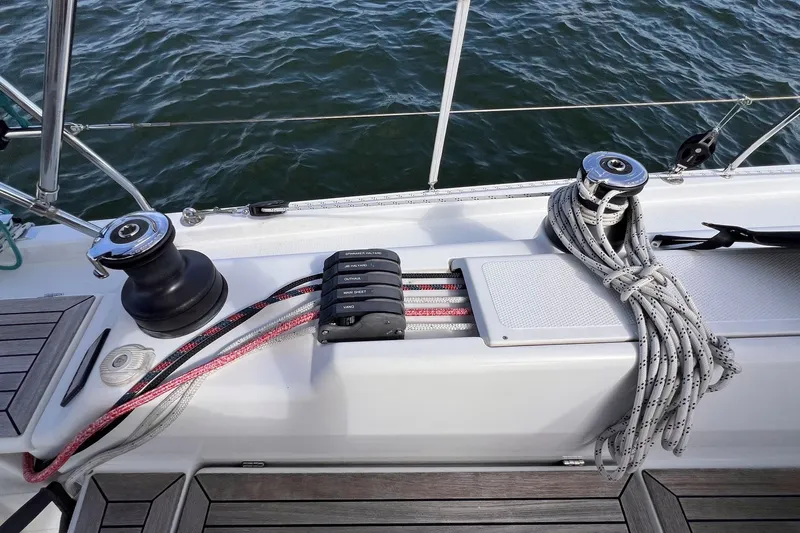 Slide: The Image of Deck of 2020 Hanse 458 sailboat with winches and ropes, overlooking water. - 26