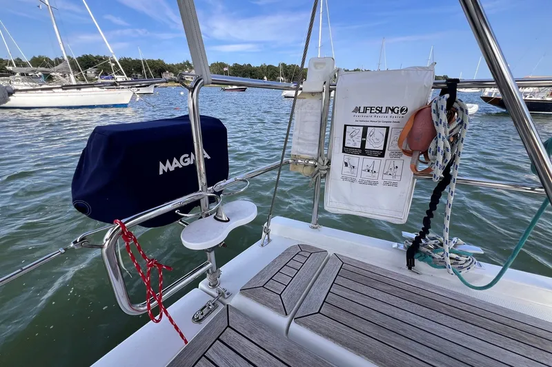 Slide: The Image of Sailing yacht Hanse 458, 2020 model, with safety equipment and scenic marina view. - 30