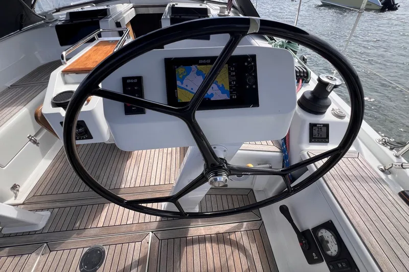 Slide: The Image of Steering wheel and navigation system on a 2020 Hanse 458 yacht deck. - 22