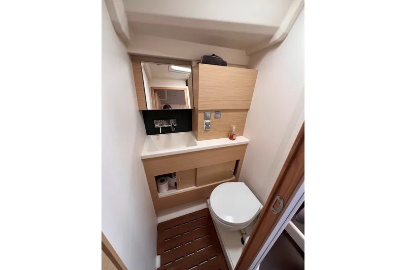 Slide: The Image of Compact bathroom in 2020 Hanse 458 yacht with modern fixtures and wooden accents. - 58