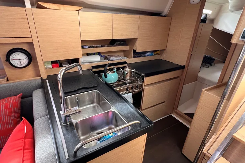 Slide: The Image of Modern kitchen interior of 2020 Hanse 458 yacht with wooden cabinetry and stainless steel sink. - 44