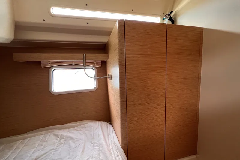 Slide: The Image of Interior cabin of 2020 Hanse 458 yacht with wooden wardrobe and window. - 63