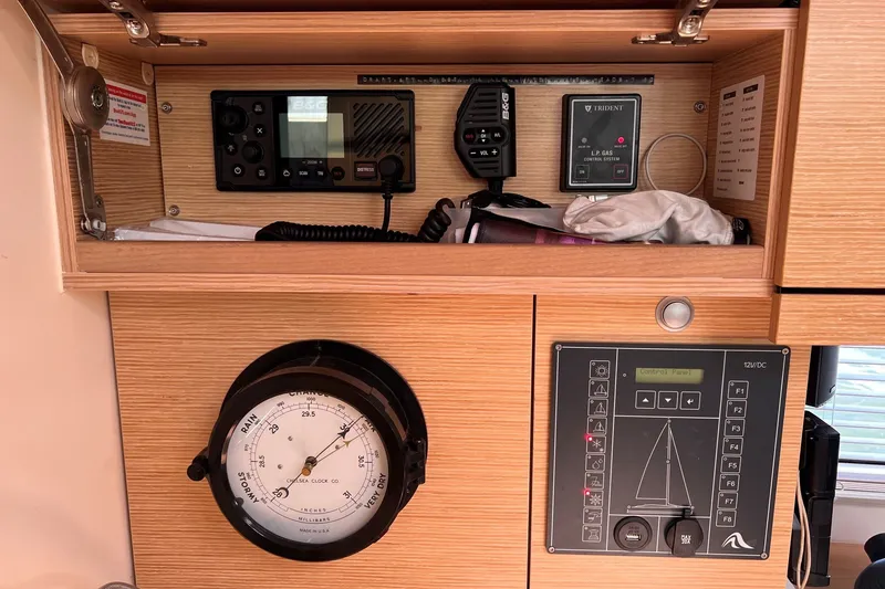 Slide: The Image of Control panel and barometer inside a 2020 Hanse 458 yacht, featuring navigation and gas systems. - 48