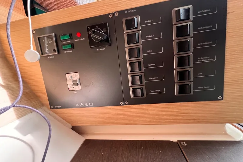 Slide: The Image of Control panel of a 2020 Hanse 458 yacht, featuring switches and circuit breakers. - 50