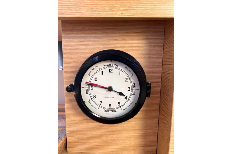 Slide: The Image of Tide clock on 2020 Hanse 458 yacht, displaying high and low tide times. - 52