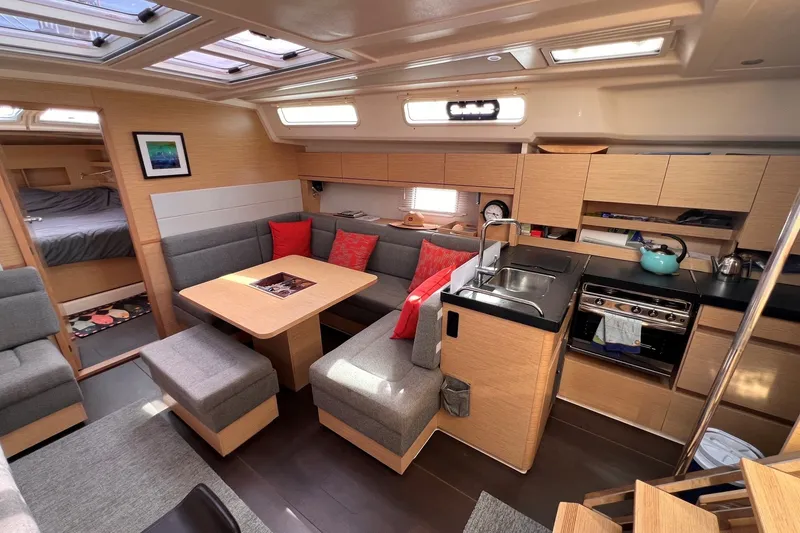 Slide: The Image of Modern 2020 Hanse 458 yacht interior with cozy seating, kitchen, and dining area. - 42