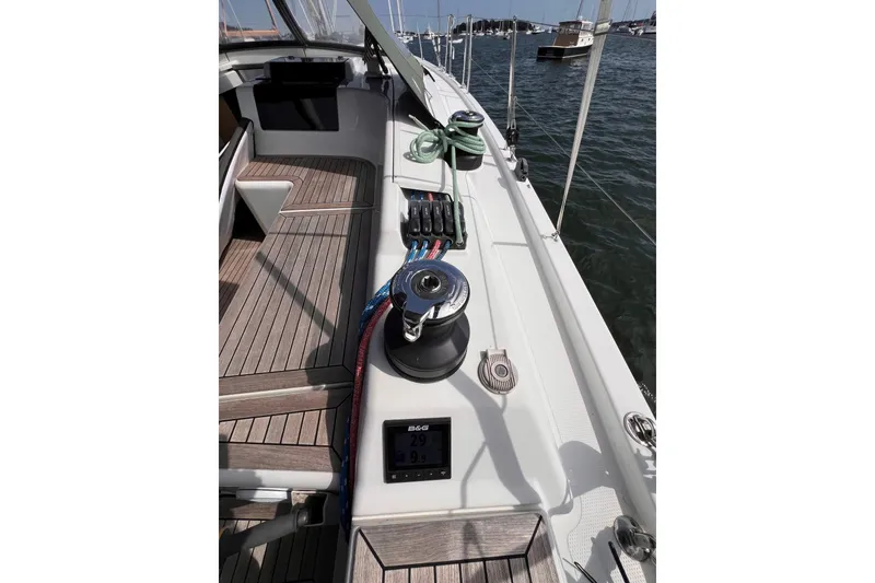 Slide: The Image of Deck view of 2020 Hanse 458 yacht with winch and ropes, sailing on calm waters. - 24