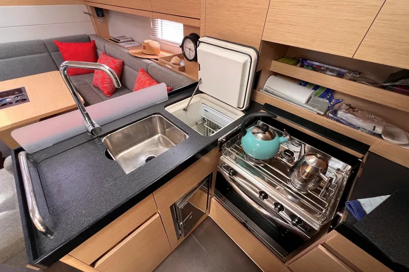 Slide: The Image of Modern kitchen in 2020 Hanse 458 yacht with sink, stove, and seating area. - 43