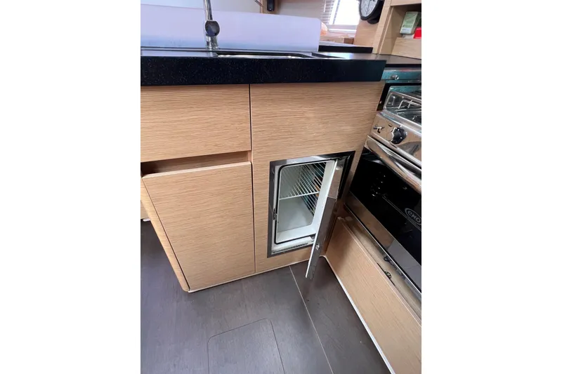 Slide: The Image of Modern kitchen interior of 2020 Hanse 458 yacht with open fridge and oven. - 46