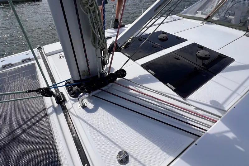 Slide: The Image of 2020 Hanse 458 yacht deck with rigging and hatches, sailing on water. - 14