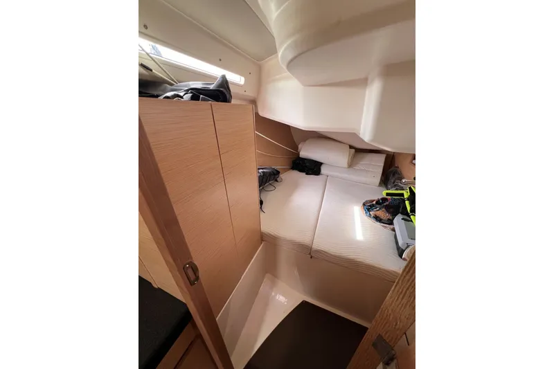 Slide: The Image of Cozy cabin interior of 2020 Hanse 458 yacht with bed and storage. - 61