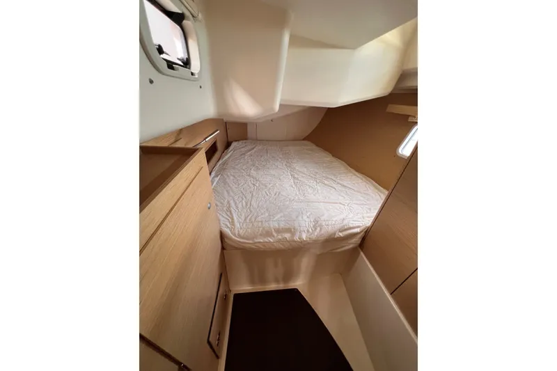 Slide: The Image of Cozy cabin interior of 2020 Hanse 458 yacht with bed and wooden cabinetry. - 62