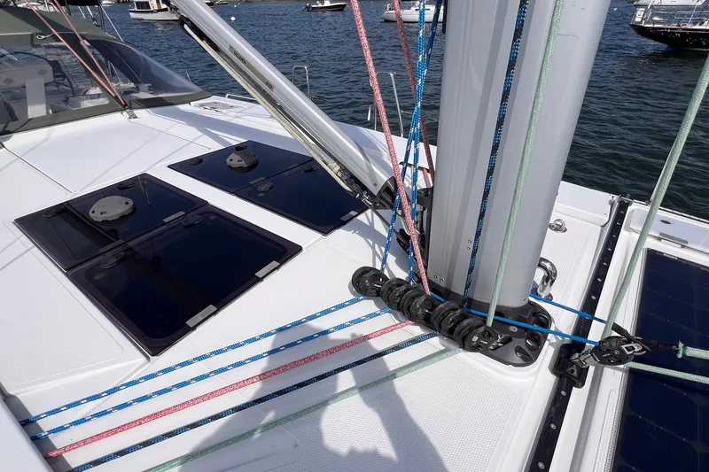Slide: The Image of Deck of 2020 Hanse 458 sailboat with colorful rigging and hatches, docked in marina. - 13