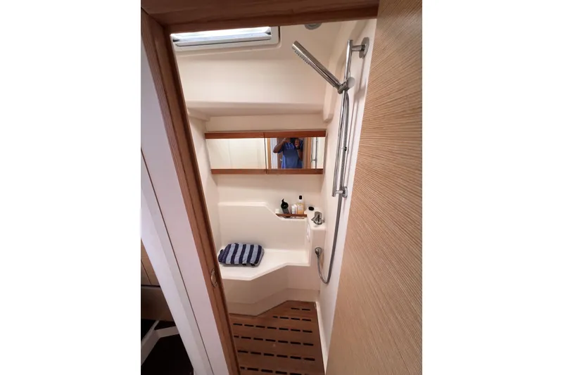 Slide: The Image of 2020 Hanse 458 yacht bathroom with modern shower and wooden accents. - 57