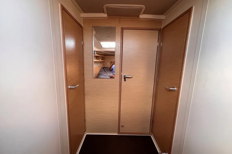 Slide: The Image of Interior of 2020 Hanse 458 yacht with wooden doors and mirror reflection. - 56