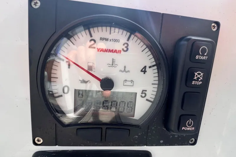 Slide: The Image of Yanmar engine control panel on a 2020 Hanse 458 sailboat, showing RPM and control buttons. - 32