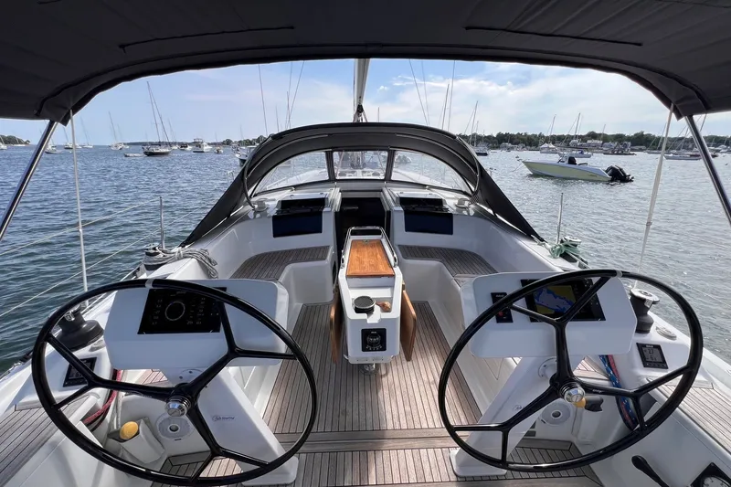 Slide: The Image of Cockpit view of 2020 Hanse 458 sailboat with dual steering wheels, docked in a marina. - 19