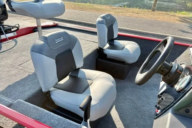 Slide: The Image of 2027 Tracker Bass Tracker Classic XL boat interior with two gray seats and steering wheel. - 15