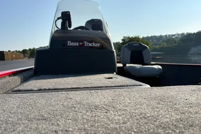 Slide: The Image of 2027 Tracker Bass Tracker Classic XL boat interior with seating and console, on a sunny day. - 20