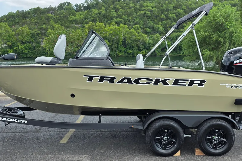 The Image of 2027 Tracker Pro Guide V-175 Combo boat on trailer by a scenic river. - 0