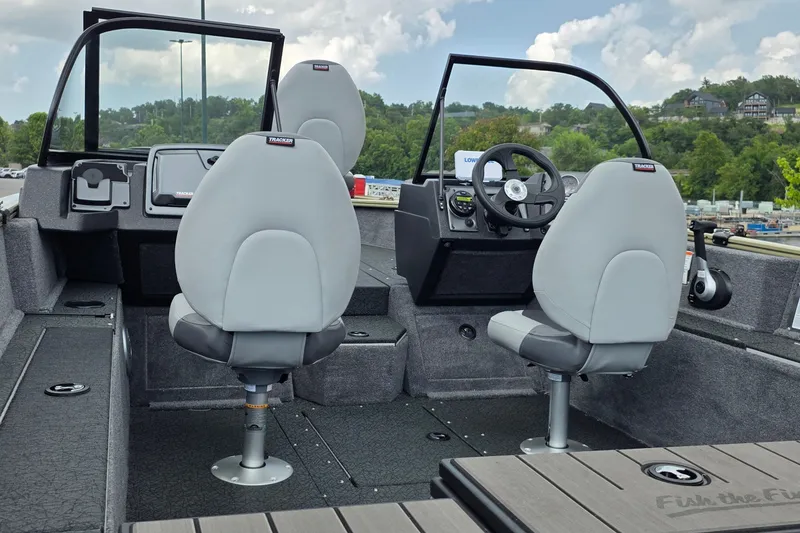 Slide: The Image of 2027 Tracker Pro Guide V-175 Combo boat interior with gray seating and steering console. - 25