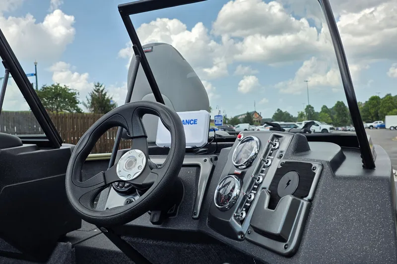 Slide: The Image of 2027 Tracker Pro Guide V-175 Combo boat dashboard with steering wheel and gauges. - 27
