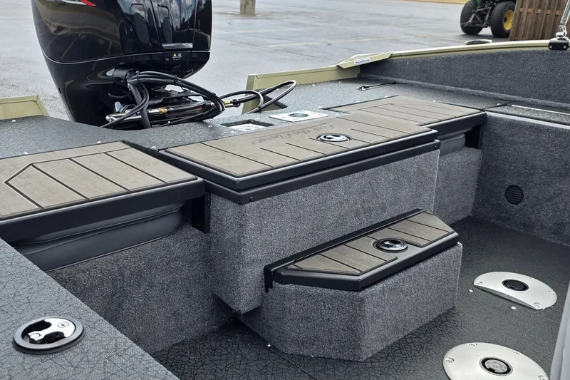 Slide: The Image of 2027 Tracker Pro Guide V-175 Combo boat interior with storage compartments and motor. - 28