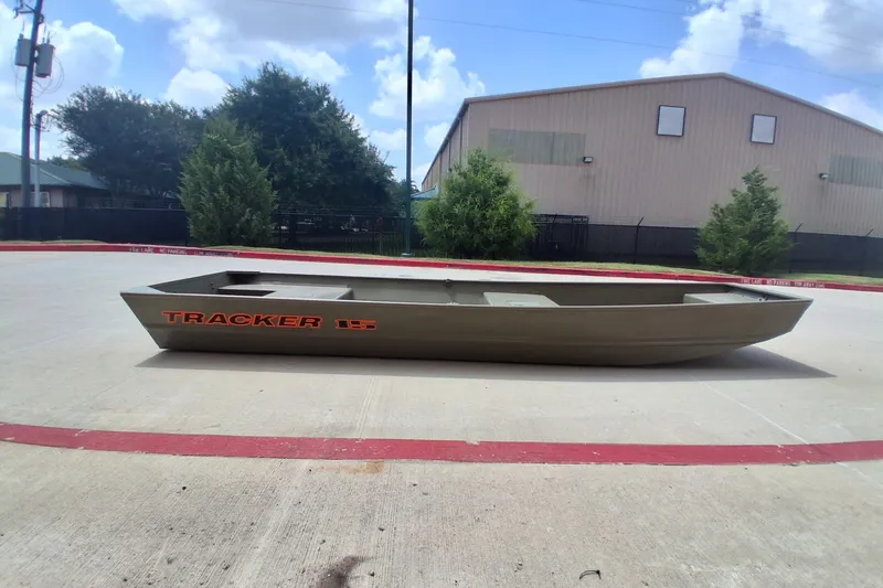 The Image of 2027 Tracker Grizzly 15 Jon boat on concrete, outdoor setting. - 0