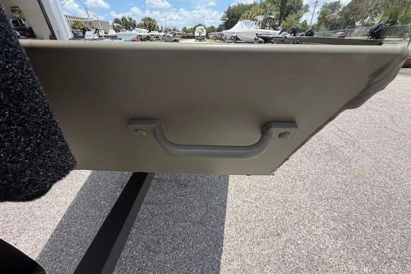 Slide: The Image of 2027 Tracker Grizzly 15 Jon boat handle, outdoor setting, sunny day, parked boats in background. - 24