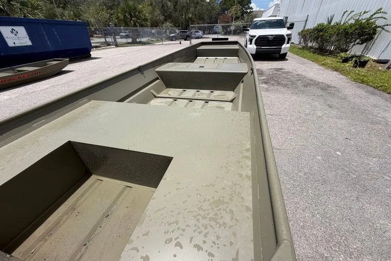 Slide: The Image of 2027 Tracker Grizzly 15 Jon boat parked outdoors on a sunny day. - 28