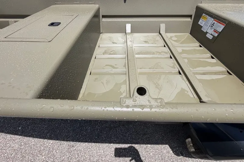 Slide: The Image of 2027 Tracker Grizzly 15 Jon boat interior with water droplets on metal surface. - 30