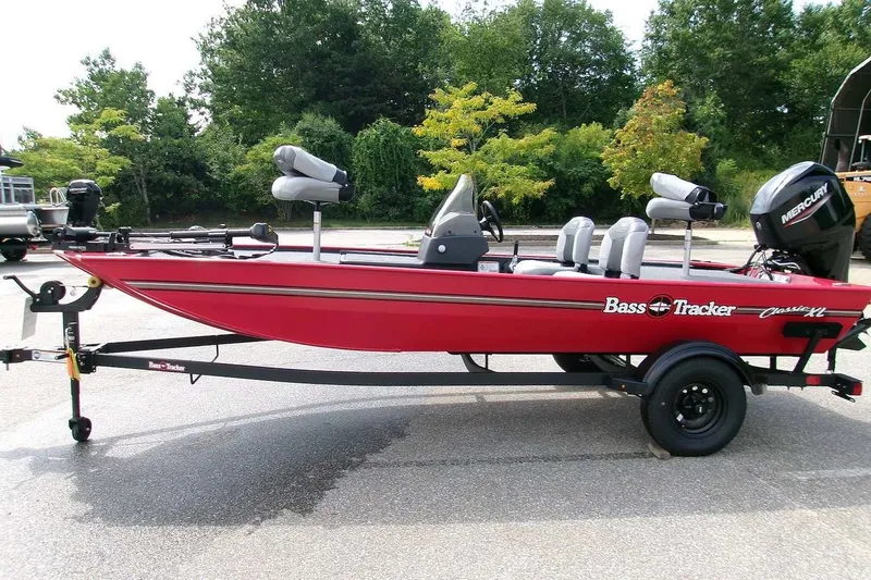 The Image of 2027 Tracker Bass Tracker Classic XL boat on trailer, parked outdoors. - 0