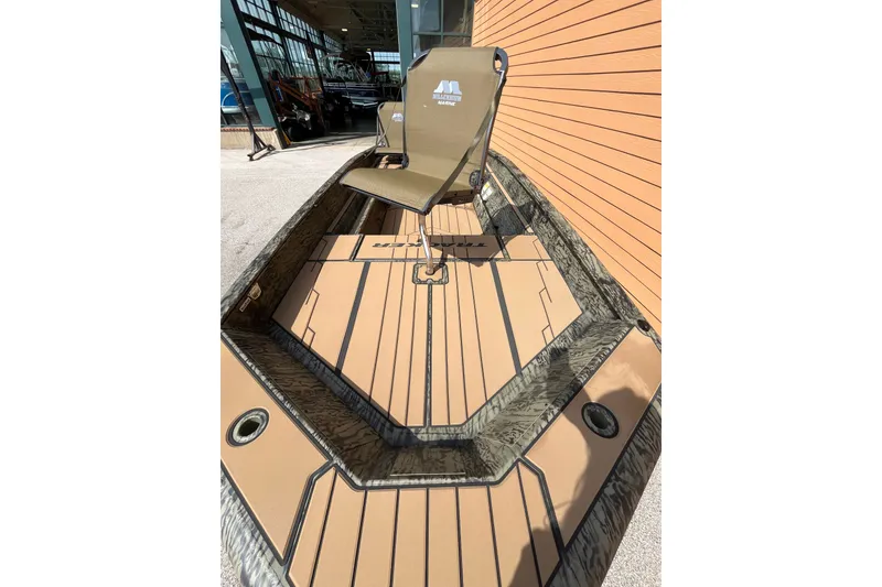 Slide: The Image of 2027 Tracker Grizzly 1553 Timber boat with a camo design and comfortable seating. - 43
