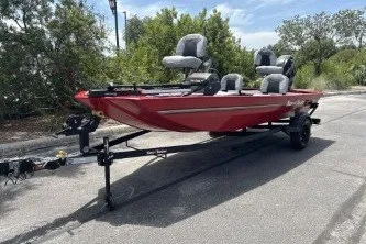 The Image of 2027 Tracker Bass Tracker Classic XL boat on trailer, parked outdoors. - 0
