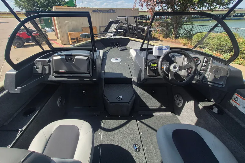 Slide: The Image of Interior view of 2027 Tracker Pro Guide V-175 Combo boat, featuring steering console and seating. - 13