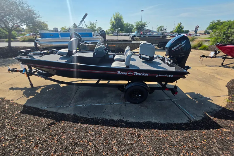 The Image of 2027 Tracker Bass Tracker Classic XL boat with Mercury engine on display outdoors. - 0