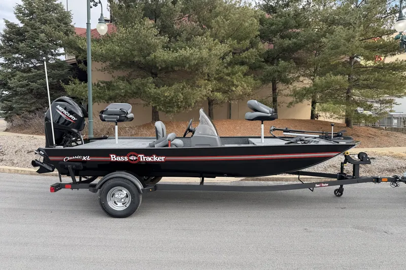 The Image of 2027 Tracker Bass Tracker Classic XL fishing boat on trailer, parked outdoors. - 0