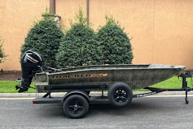 The Image of 2027 Tracker Grizzly 1553 Timber boat on trailer, parked outdoors. - 0
