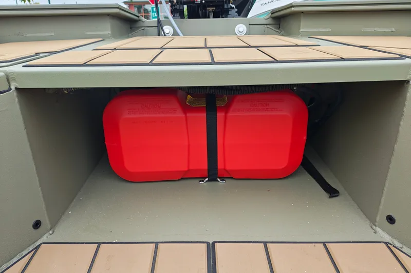 Slide: The Image of Red fuel tank secured in a 2027 Tracker Grizzly 1553 Timber boat compartment. - 19