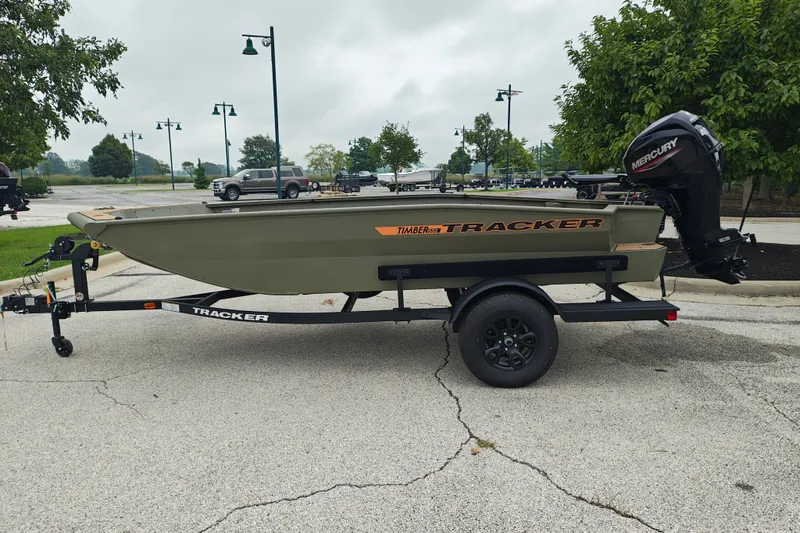 The Image of 2027 Tracker Grizzly 1553 Timber boat on trailer, parked outdoors. - 2