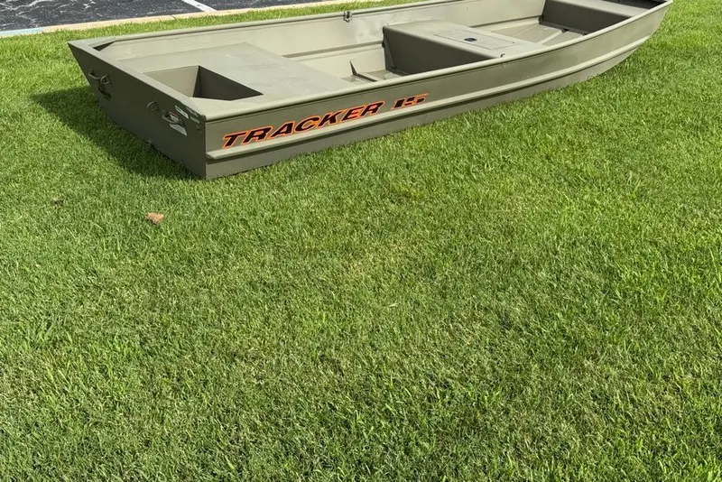 The Image of 2027 Tracker Grizzly 15 Jon boat on green grass. - 0