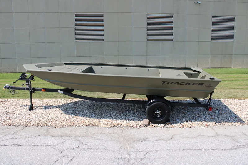 The Image of 2027 Tracker Grizzly 1648 Utility boat on trailer, parked outdoors. - 0
