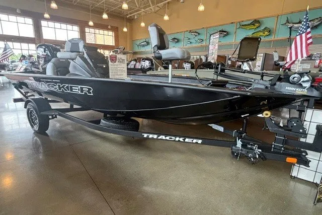 The Image of 2027 Tracker Pro Team 175 boat displayed indoors with American flags. - 0