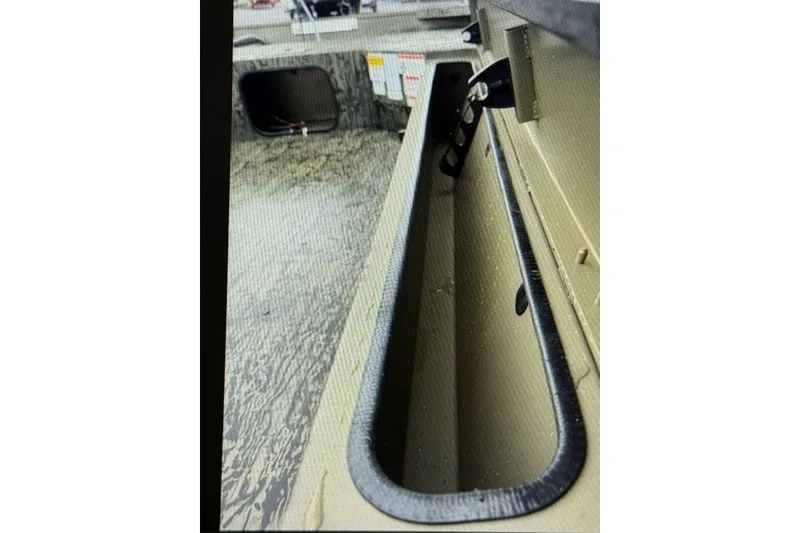 Slide: The Image of Interior view of 2027 Tracker Grizzly 1654 T Sportsman boat storage compartment. - 13