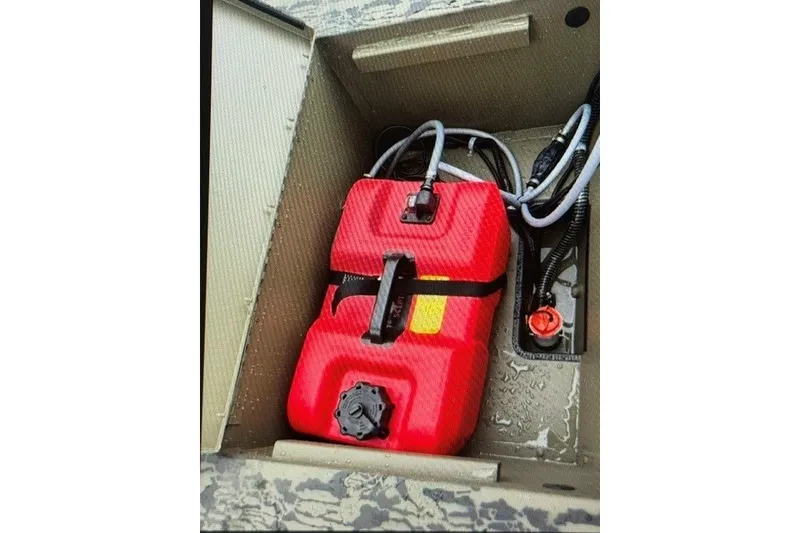 Slide: The Image of Red fuel tank in 2027 Tracker Grizzly 1654 T Sportsman boat compartment. - 15
