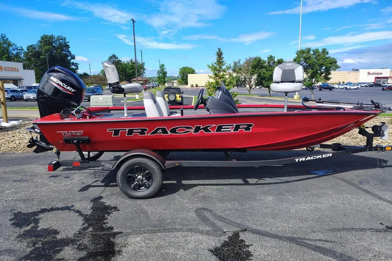 The Image of 2027 Tracker Pro Team 175 boat in vibrant red, parked outdoors on a trailer. - 0