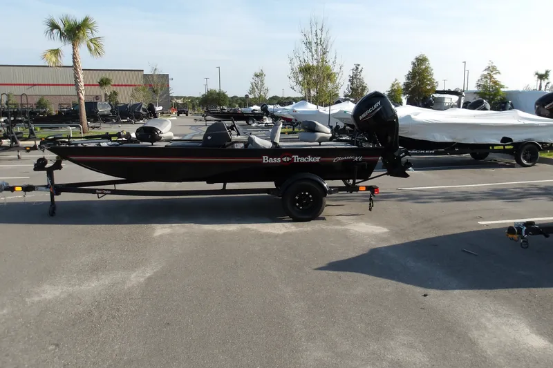 The Image of 2027 Tracker Bass Tracker Classic XL boat parked outdoors on a trailer. - 1