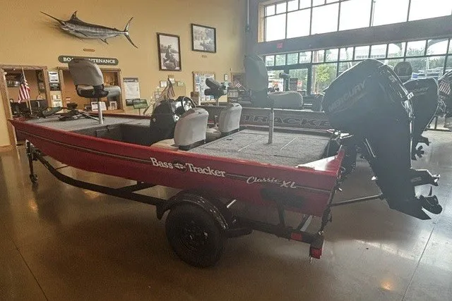The Image of 2027 Tracker Bass Tracker Classic XL boat displayed indoors with Mercury engine. - 0